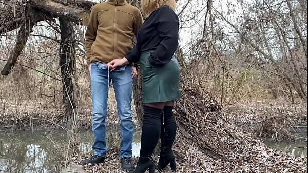 Mother-in-law holds dick while outdoors