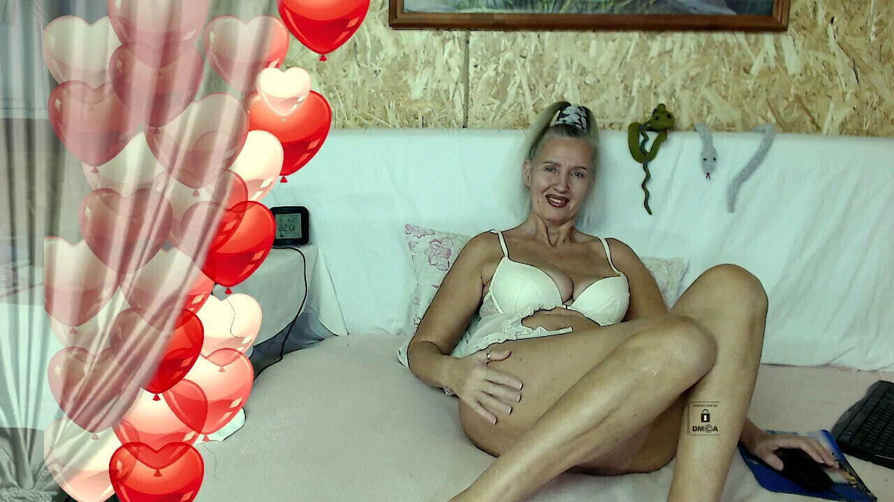 Hot housewife Lukerya on the bed in white lingerie