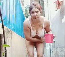 Desi aunty bathing outside