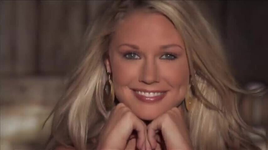 Kelly Carrington playful blonde shows naked body courtyard