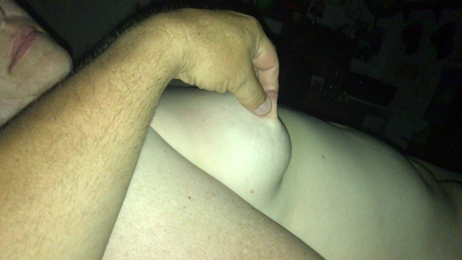 In bed playing with her boob. 