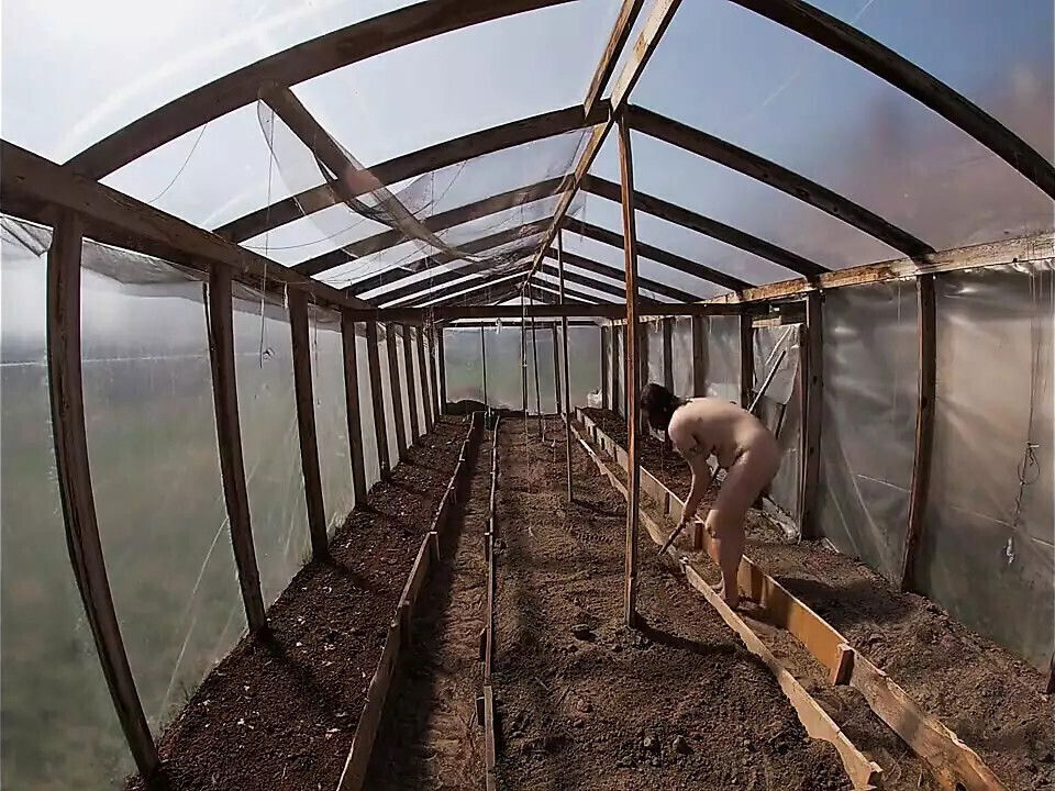 Nude house wife working greenhouse