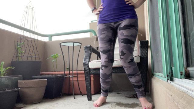 girl wetting grey leggings outside balcony