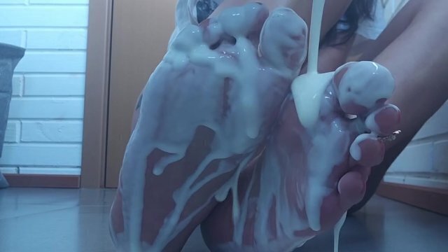 Excited woman pours milk feet believing