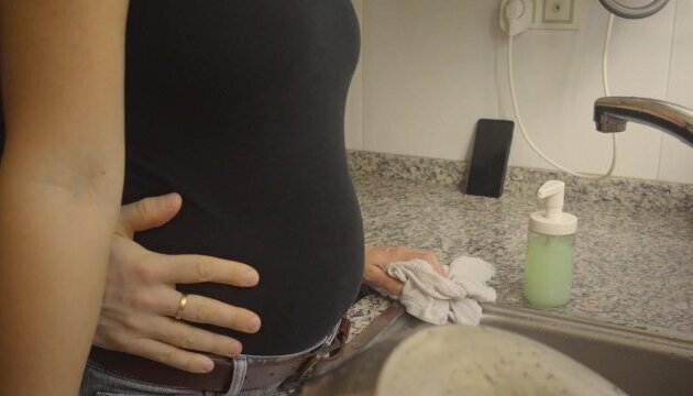 Washing dishes black jeans