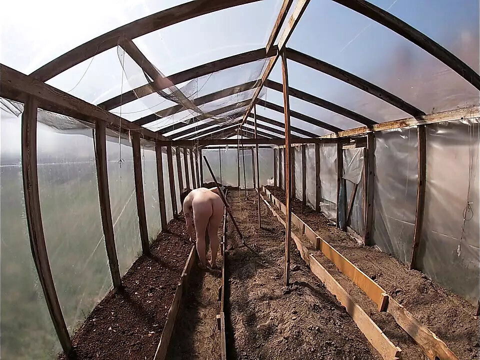 Nude house wife working greenhouse