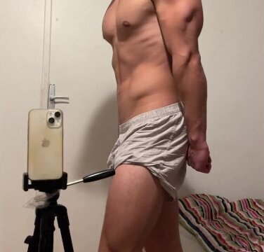 Young bodybuilder showing muscles boxer shorts