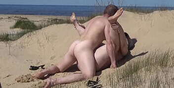 Helping juicy female on beach