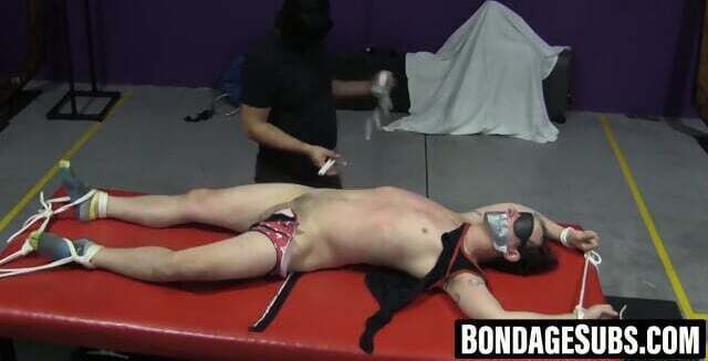 Twink Casey fights against pins clamping naked body parts