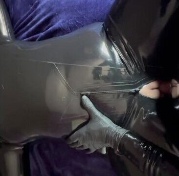 Latex bondage, strap-on penis plugging.