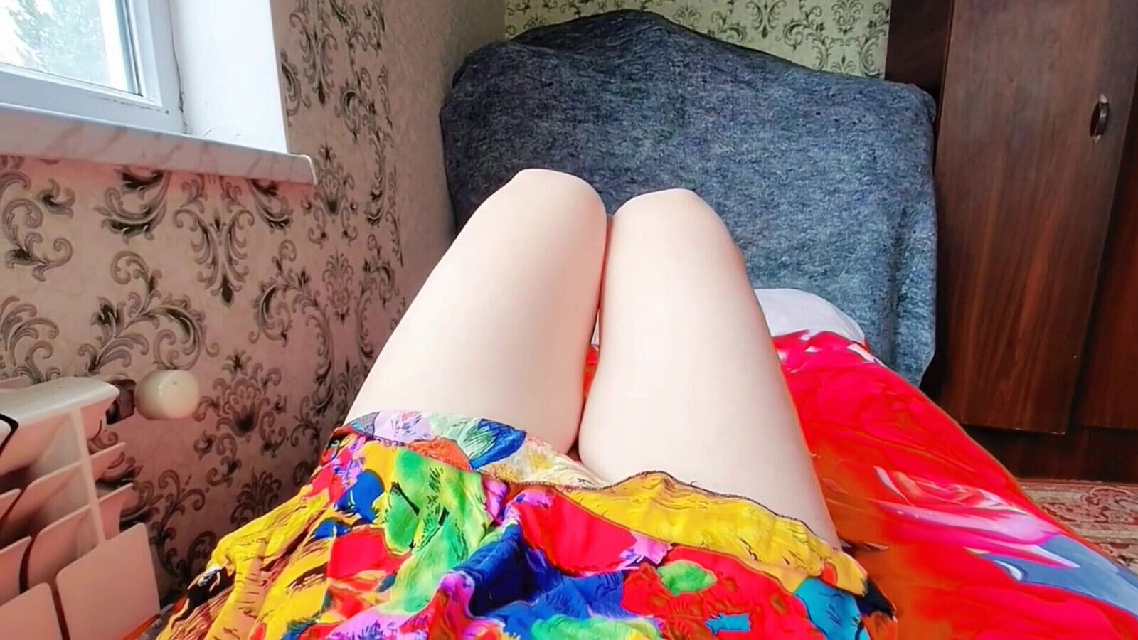 Sweet femboy leaning balcony railing sunset