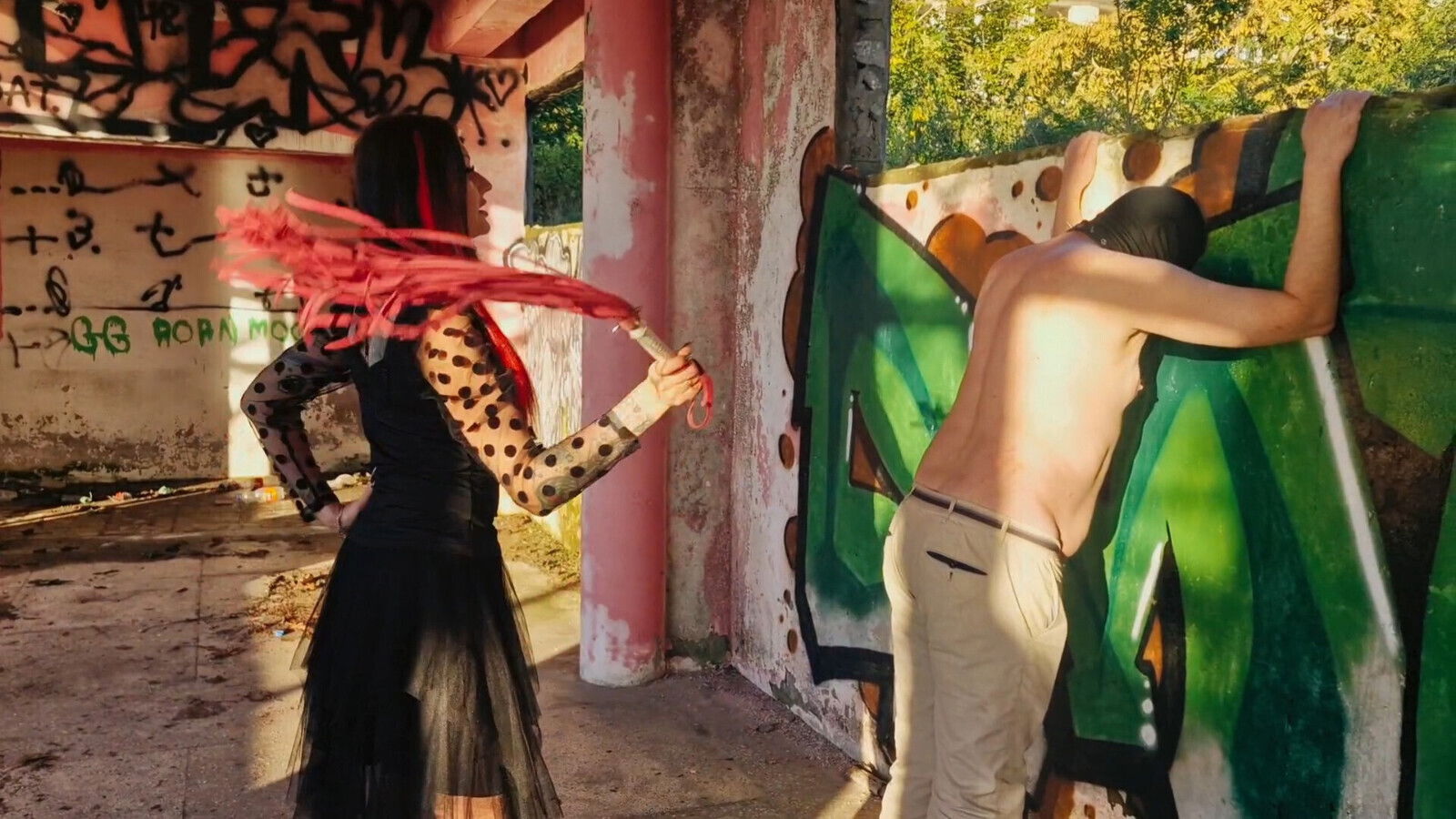 BDSM femdom flogging. Dominatrix Nika punishes slave sunset abandoned building. Back scratching.