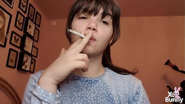 Big lips covered in lipgloss smoking with close up of the lips