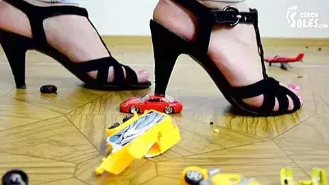 Mad Amateur Girl Crushing Car Toys With Her Black High Heel Shoes