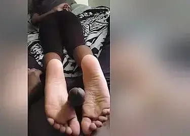 Caucasian Babe Giving A Passionate Footjob To A Black Dude In A Reverse Position
