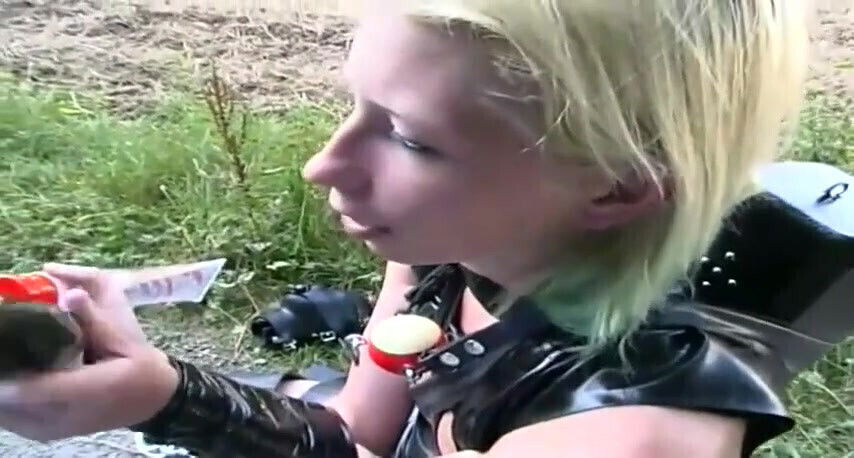 Masked blonde chick posing in leather outfit