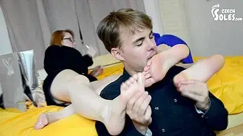 Young Slave Massages And Licks Attractive Females Feet In Bed