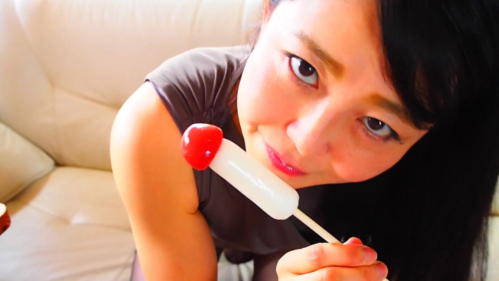 Horny Asian MILF sucking on candy dick