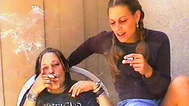 Two sexy chicks smoke together
