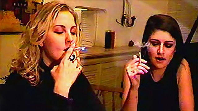 Sexy girls smoke cigarettes joint