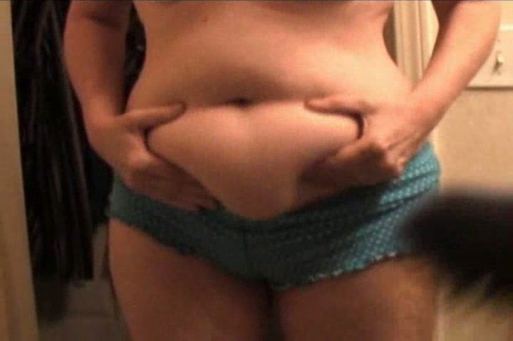 Showing off my big belly to my husband with a camera