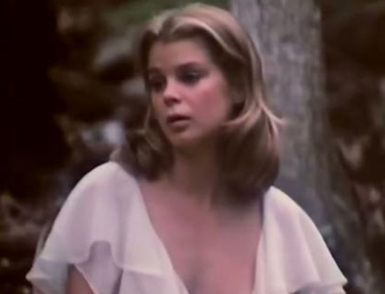 Lustful babe Kristine DeBell is masturbating passionately in the woods