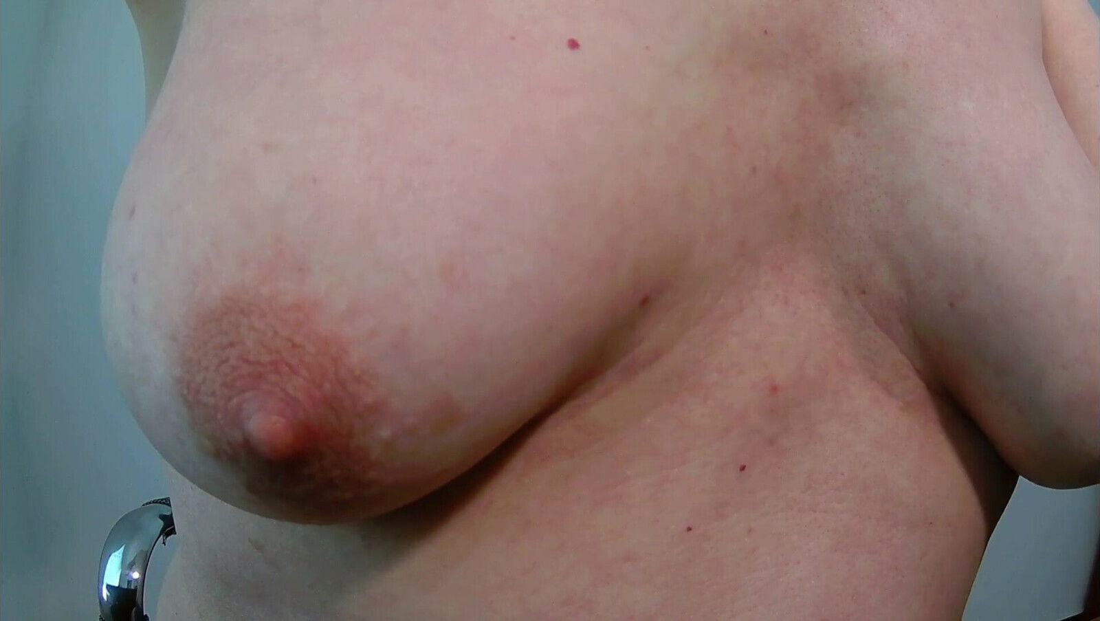 Susan is showing her breasts while sitting at the desk