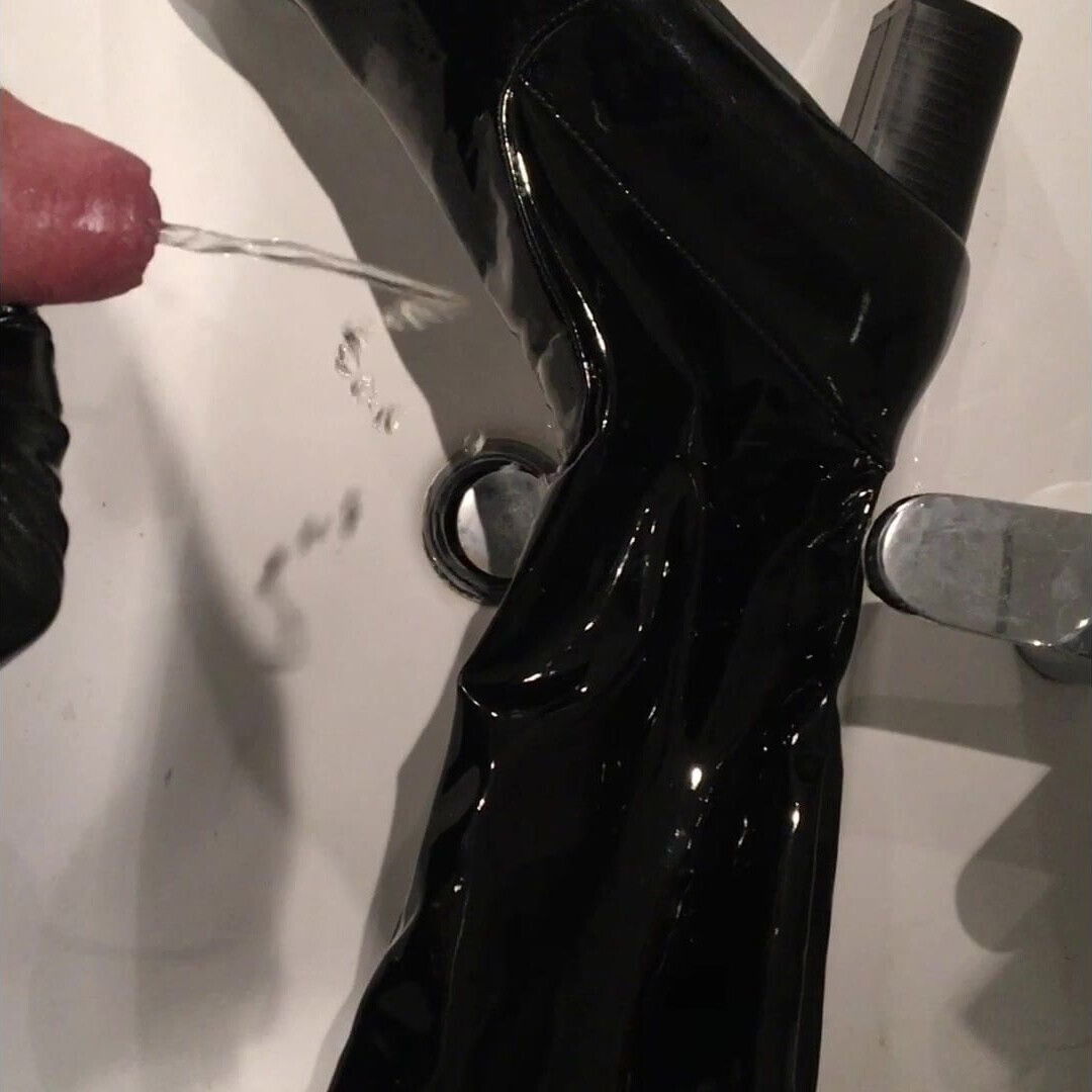 Abusing and pissig on her black patent overknee boots
