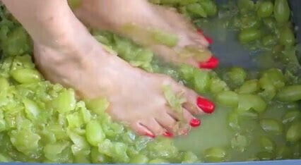 Feet with Long Red Toenails Stomping Green Grapes (II part)