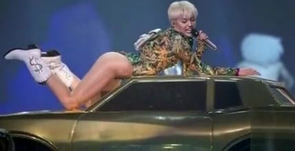 Miley Cyrus slideshow with erotic scenes revealing outfits