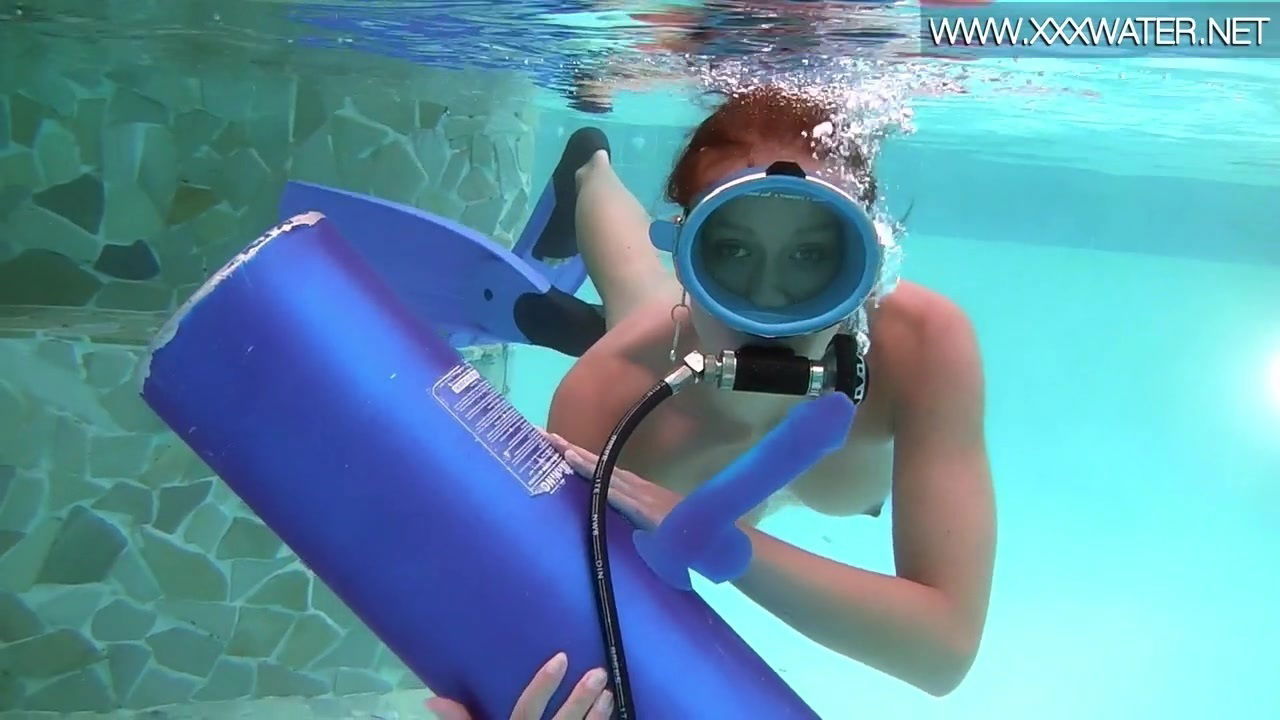 Scuba diving girl in a pool sucks on a dildo