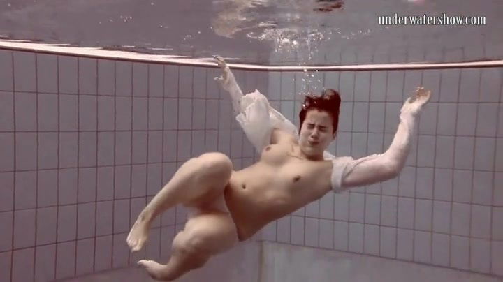 Big butt girl enjoys a naked swim in the pool