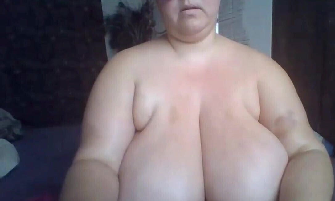 MILF in glasses with huge natural tits showing