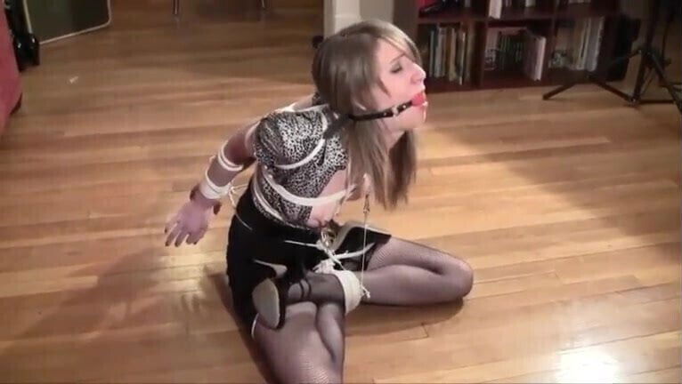 Gagged slave tied with nipple clamps