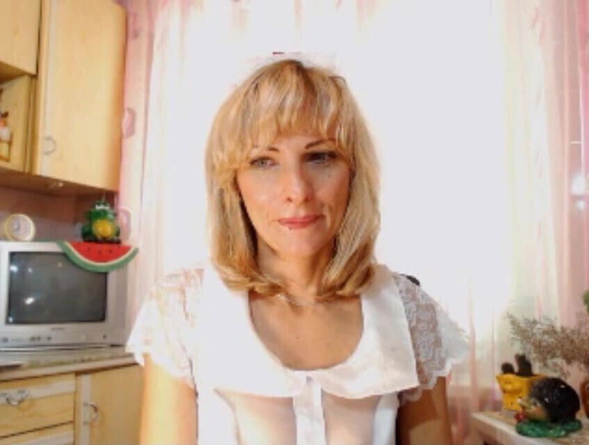 Mom is naughty in the kitchen at the camera.