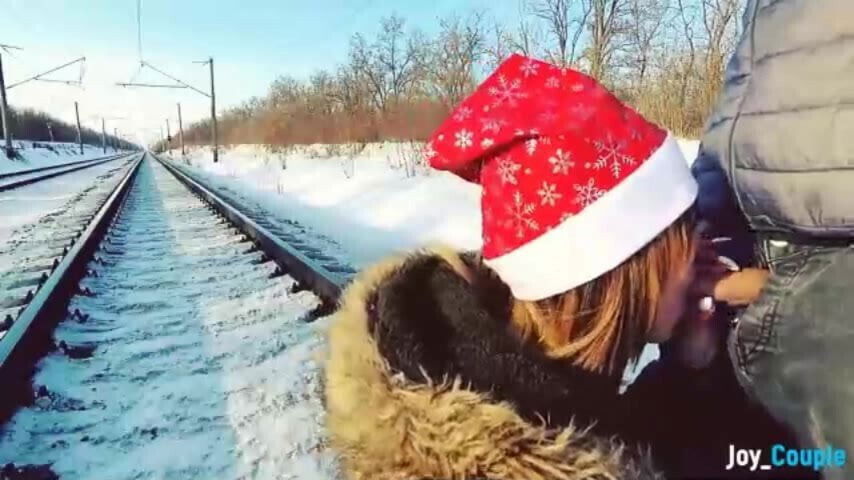 Girl in fur coat give blowjob on railway