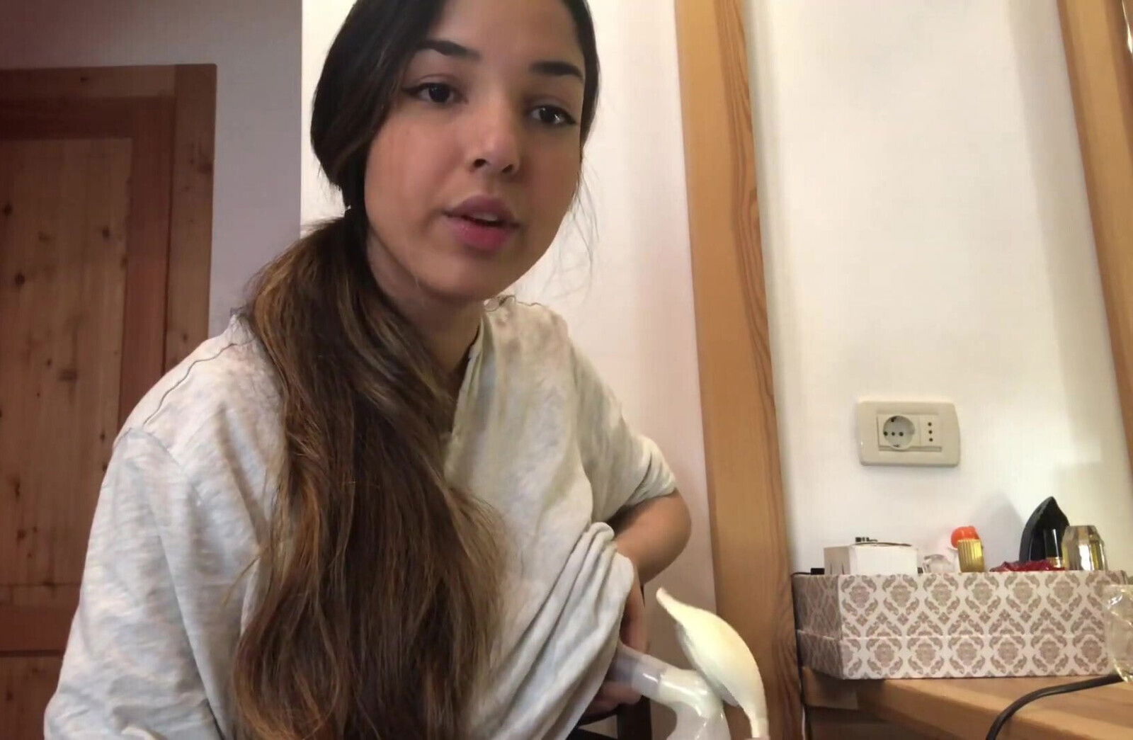 young Latina Angela pumps milk from nipple