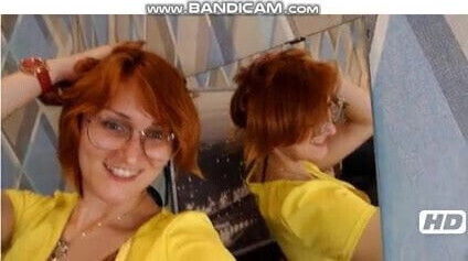 Gorgeous redhead stripping showing.