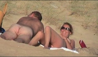 Hot amateurs enjoying sex on a sandy public beach