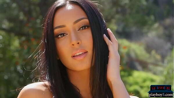 Gorgeous exotic slim Playboy model stripteasing outdoor