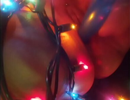 TEEN MILF FUCKS SELF WITH CHRISTMAS LIGHTS UNTIL