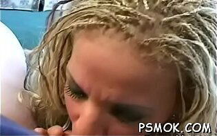 Charming chick with huge bust poses camera while smoking