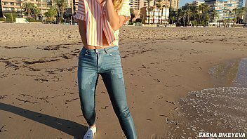 shoot public beach with Crazy Model. Risky outdoor masturbation. Foot fetish. jeans.