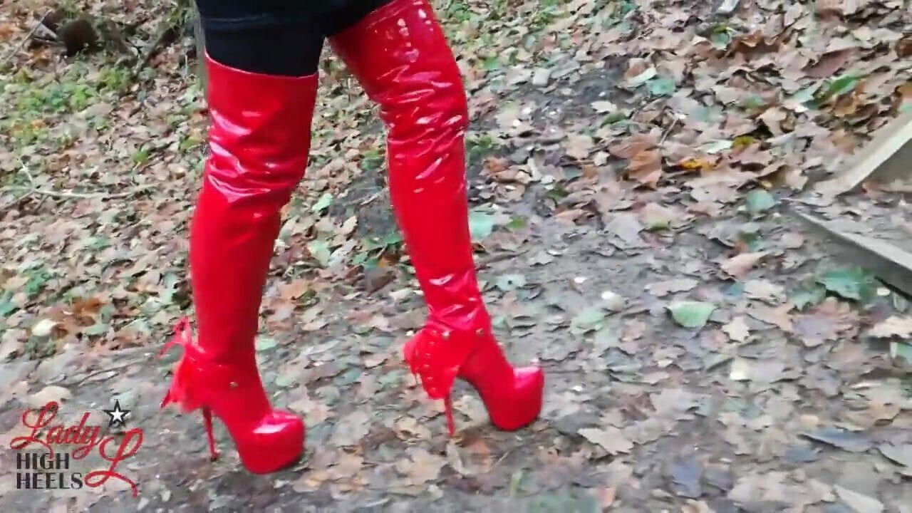 Lady sexy walking with extreme boots forest.