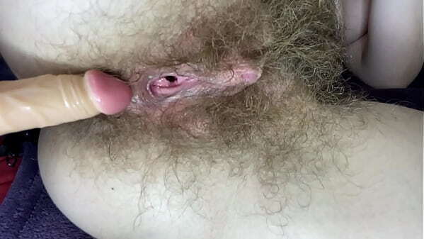 Hairy girl fucks clit pussy with dildo close