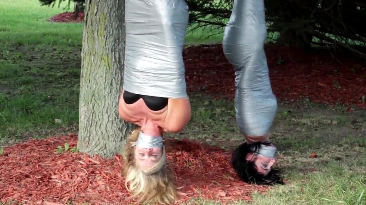 girls duct tape mummies outdoors