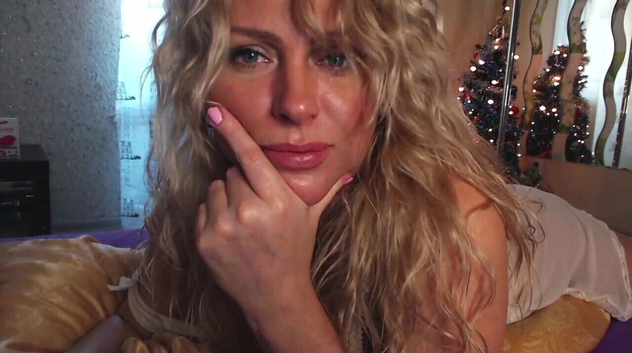 Blonde with beautiful curly hair shows herself camera