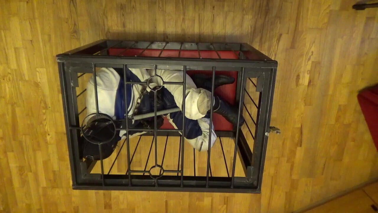 Bound leather suit caged