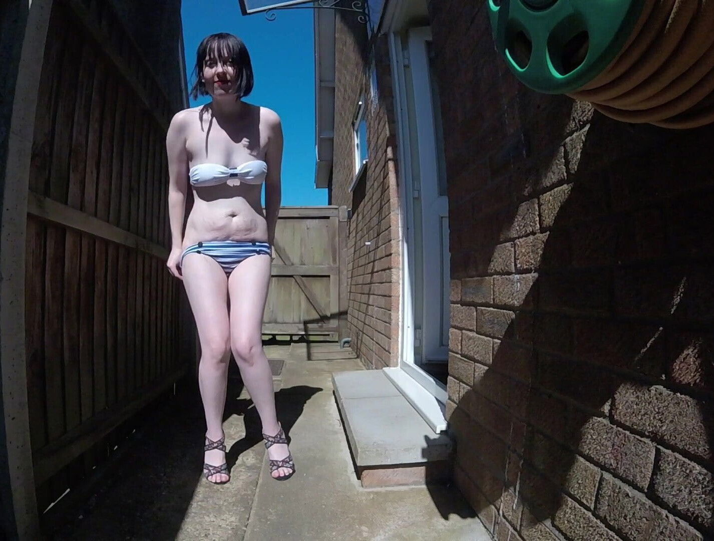 Skinny British Wife wearing retro swimwear Outdoors