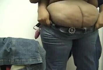 A beautiful black ass getting help putting her jeans on.